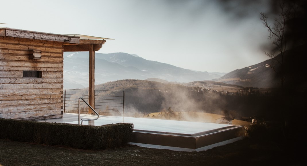 The heated outdoor whirlpool with a mountain view in winter