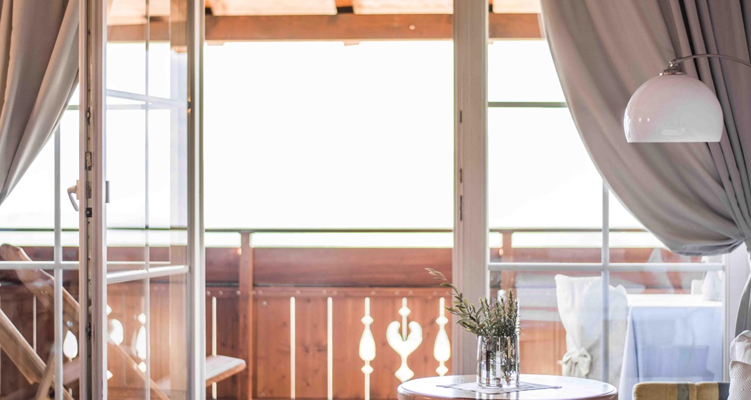 Bright room with view of wooden balcony