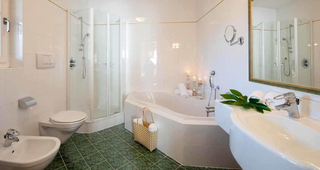 Bathroom with bathtub, shower, sink, toilet, and bidet