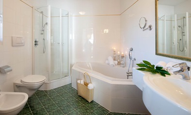 Bathroom with bathtub, shower, sink, toilet, and bidet