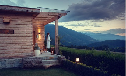 A women is enjoying the view on the mountains in the evening