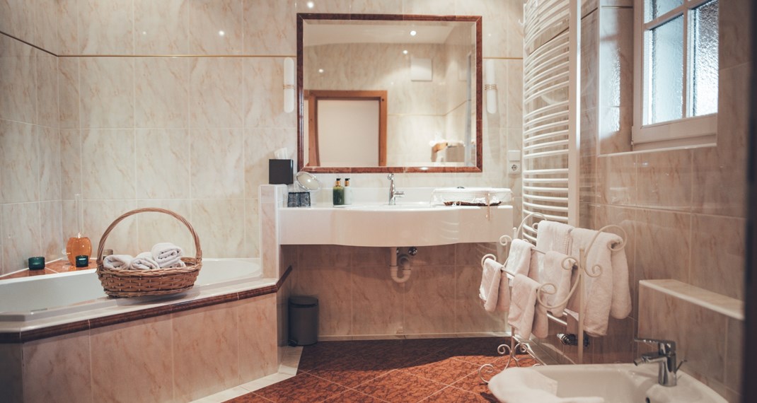 The bathroom with bathtub, sink, and bidet